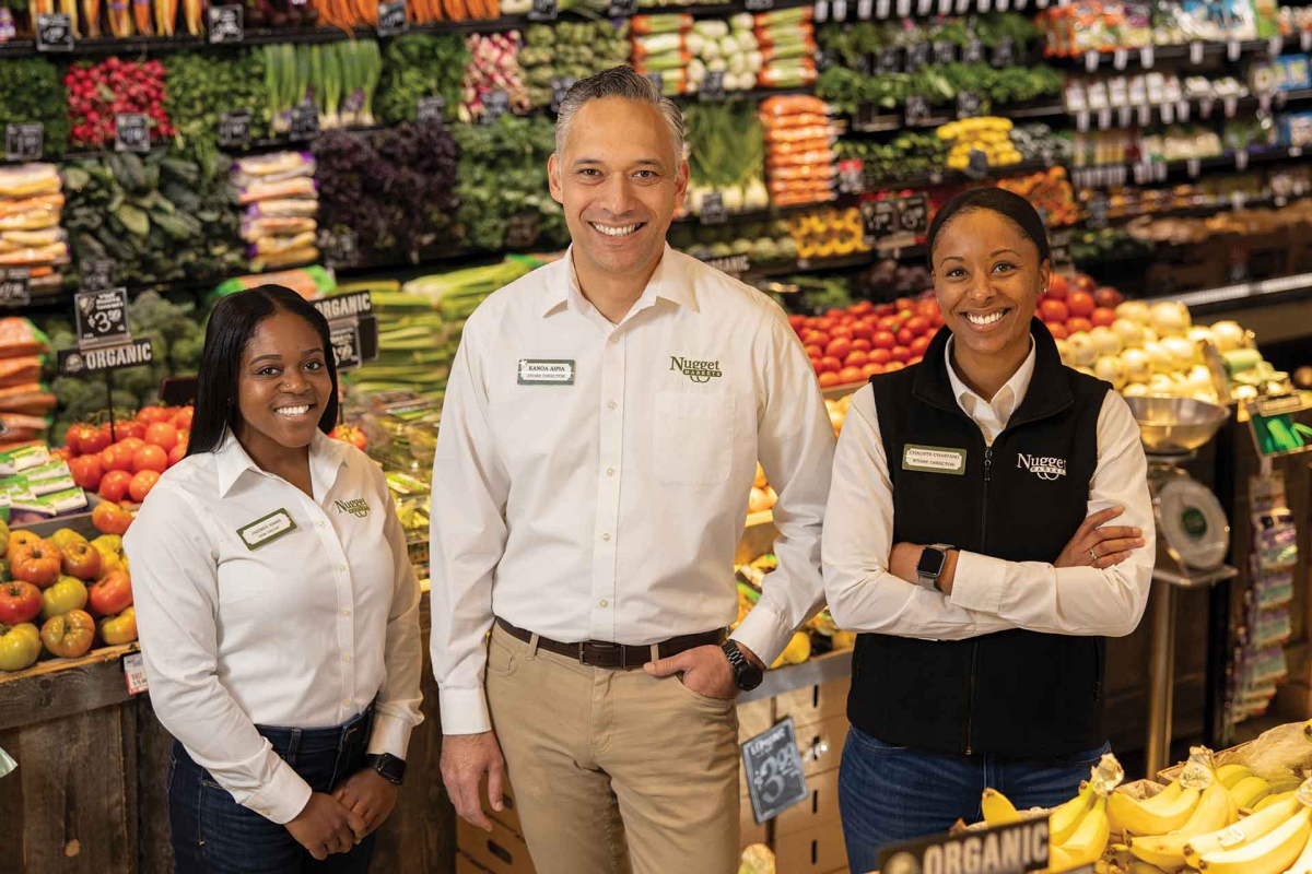 Nugget Markets Store Directors standing in the produce section