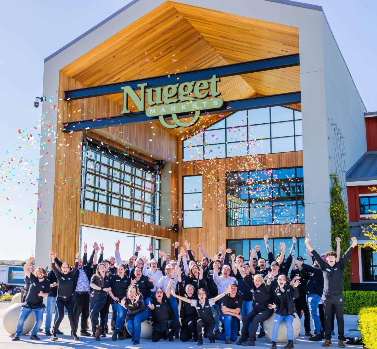 Nugget Market Roseville associates celebrating outside the store with confetti.